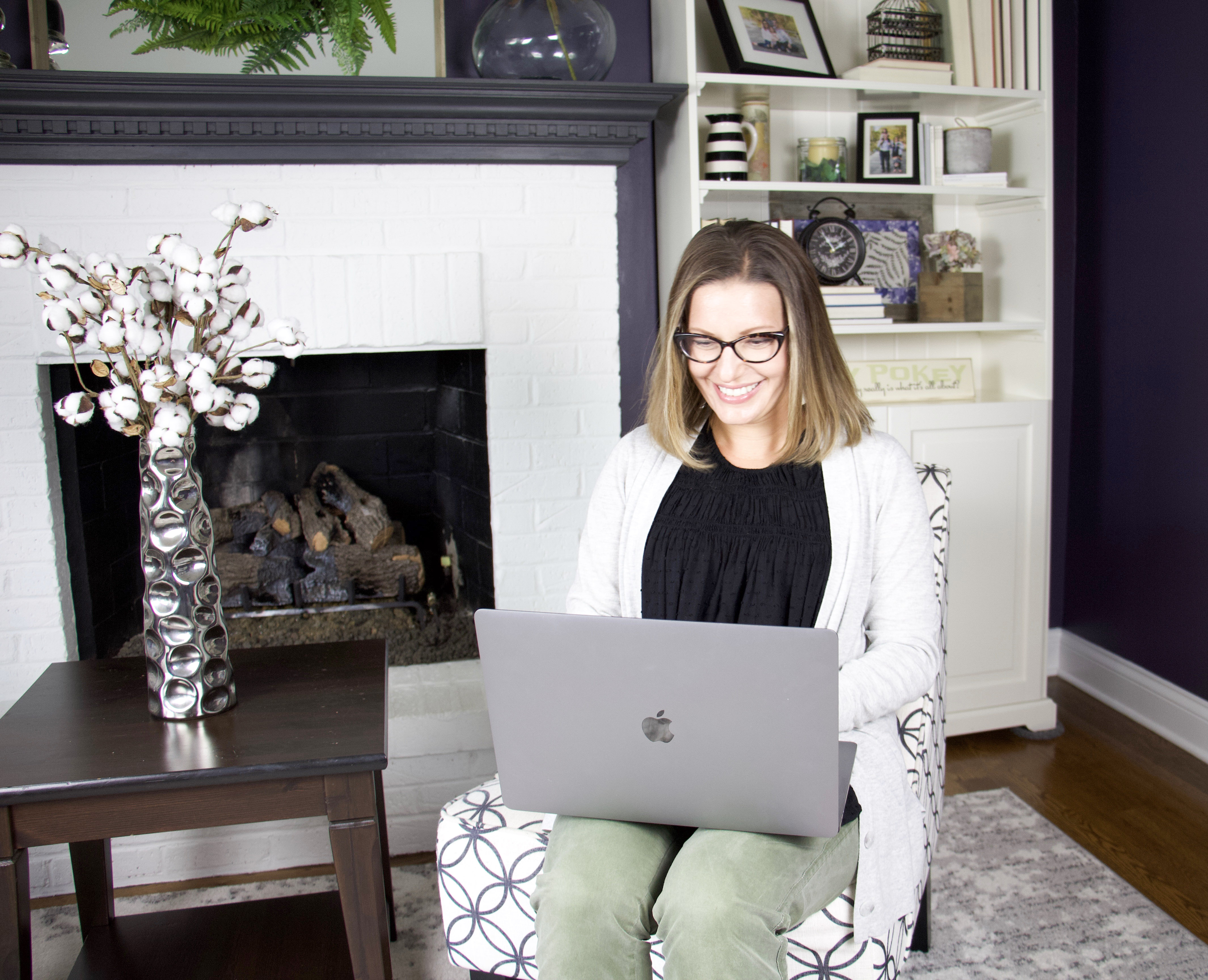 the organized mama on computer in living room